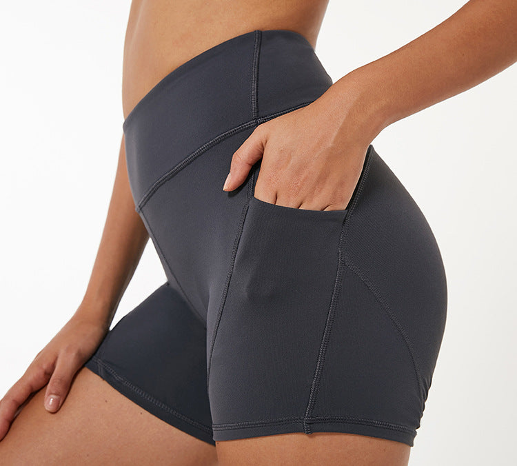 Pantalones cortos de yoga ajustados y elásticos de bolsillo